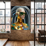 A large vertical canvas print of a futuristic woman in a gold Kintsugi style bodysuit and green sunglasses, with emeralds and diamonds embellishments displayed on a brick wall in a modern loft room with wood floors and windows.