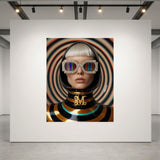 A framed fashion portrait print displayed on a white gallery wall, showing a person in a glossy black helmet with rainbow-striped sunglasses and a striped black, gold and turquoise outfit against a swirling multicolour background.