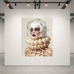 A large museum-grade framed artwork displayed on a white gallery wall, showing a surreal portrait of a woman with a white helmet-like headpiece, silver diamond accents, dark crystal eye masks with crystal tear droplets and a pearl-like caged ruff collar against a beige background.