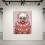 A surreal portrait artwork displayed on a large white gallery wall. The artwork features a figure with a white bob haircut, pale skin with metallic patterns, and a voluminous pink collar with pink bubble-like glass accents, set against a solid pink background. 