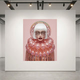 A surreal portrait artwork displayed on a large white gallery wall. The artwork features a figure with a white bob haircut, pale skin with metallic patterns, and a voluminous pink collar with pink bubble-like glass accents, set against a solid pink background. 