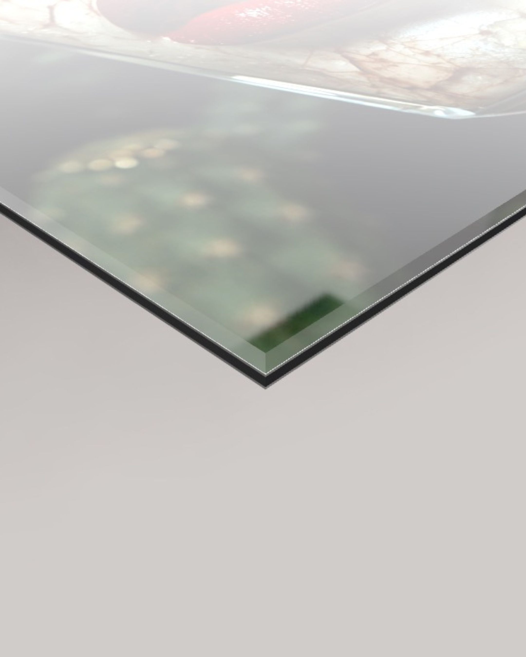 A close-up of a transparent 4mm glass panel shown at an angle against a light grey background.