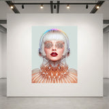 A large square wall art print displayed on a white gallery wall, featuring a stylized portrait of a woman with silver hair, metallic mesh sunglasses, and a reflective geometric collar against a pale blue background. The print is shown in a modern gallery space with track lighting and concrete floors.