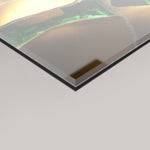 A close-up angled view of a 4mm glossy rectangular panel, showing details of the Karat artwork's surface with gold, green, and beige tones on a light grey background.