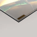 A close-up angled view of a 4mm glossy rectangular panel, showing details of the Karat artwork's surface with gold, green, and beige tones on a light grey background.
