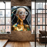 A large wall art print or poster displayed in a modern loft-style room with exposed brick walls, wood floors, and large windows. The artwork depicts a stylized portrait of a platinum blonde  woman with metallic gold skin, silver flower-shaped sunglasses, and green and blue accents against a dark circular background.