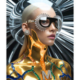 A stylized portrait of a woman with a sleek platinum blonde hair, pearl stud earrings and clear sun-like visor sunglasses, with a highly reflective metallic gold bodysuit and sapphire, emerald and ruby precious gemstone accents against a black-and-white radial background.