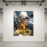 A large wall art print displayed on a white gallery wall, showing a stylized futuristic portrait of a woman with sleek platinum blonde hair, black sunglasses, and metallic gold skin details against a black and white radial glass background. 