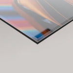 A close-up angled view of a 4mm glossy rectangular panel with a reflective metallic finish, showing the warmth of the Resonance artwork colours