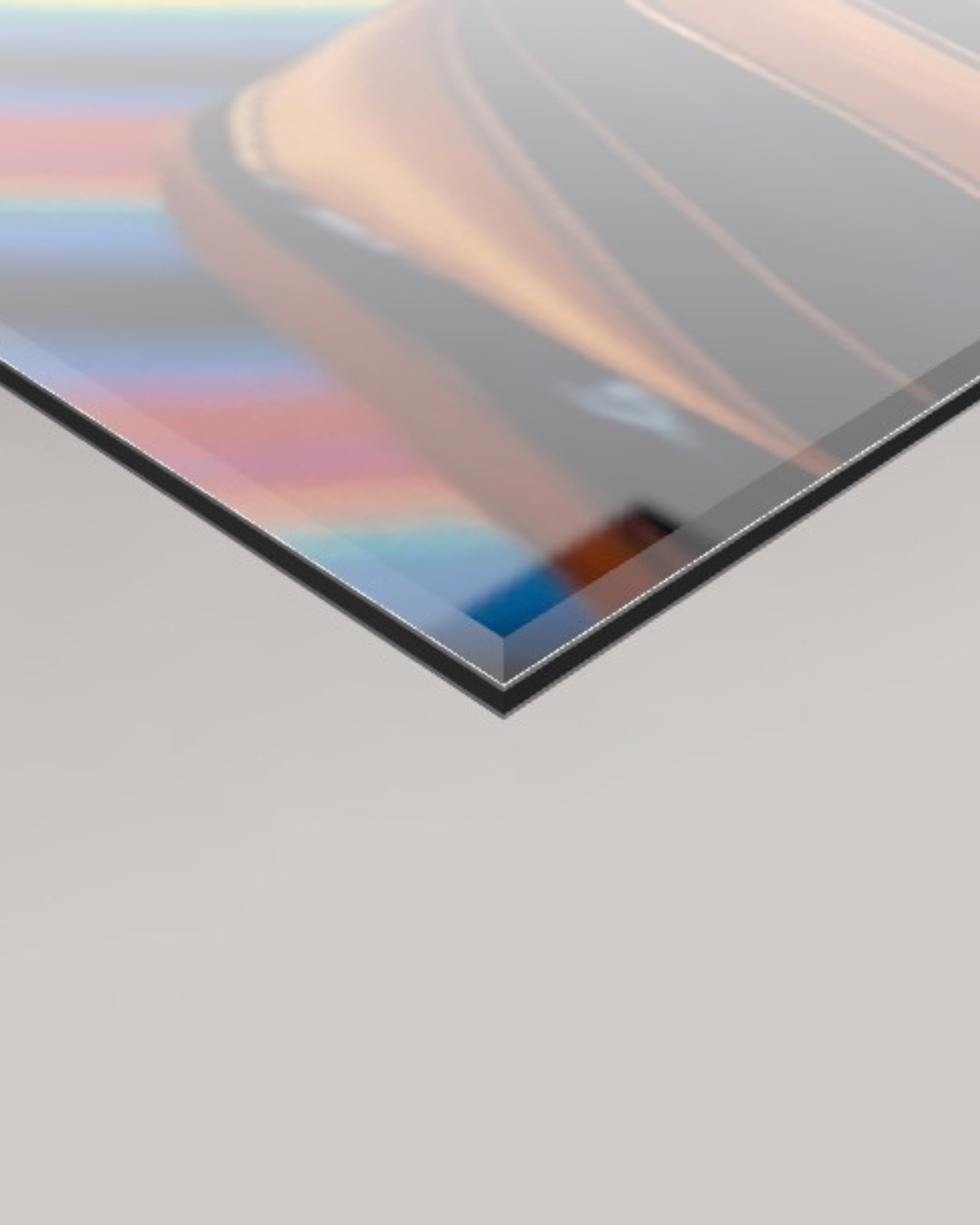 A close-up angled view of a 4mm glossy rectangular panel with a reflective metallic finish, showing the warmth of the Resonance artwork colours