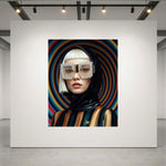 A fashion portrait of a gorgeous asian platinum blonde model set in a luxurious acrylic glass frame displayed on a white gallery wall. The model is wearing a glossy black helmet with crystal-striped sunglasses and a striped black, gold and green outfit against a swirling multicolour background.