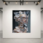 A fashion artwork set in a luxurious museum-grade acrylic glass frame displayed on a large white gallery wall, featuring a woman with a triangular crystal headpiece adorned with pale pink flowers, diamond "M" monogram earrings with matching diamond necklace set on a dark background.
