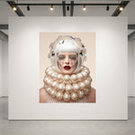A large museum-grade framed artwork displayed on a white gallery wall, featuring a stylized portrait of a woman with a white bob hair, dramatic pearl-like collar, and crystal tear drops, featured  in a modern gallery space with track lighting.